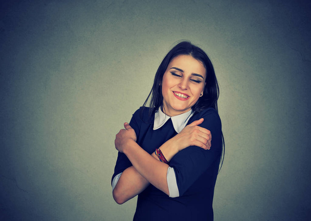 smiling woman holding hugging herself - Photo, Image