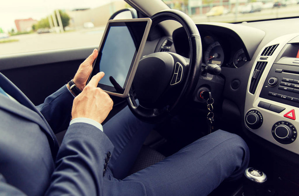 close up of young man with tablet pc driving car - Фото, зображення