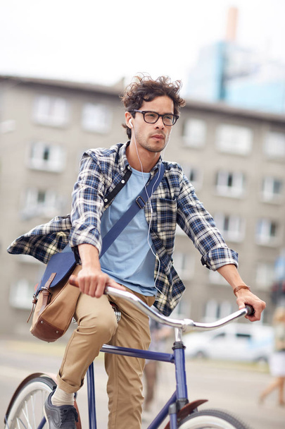 young hipster man with bag riding fixed gear bike - Photo, Image