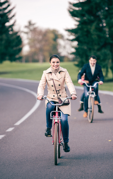 Beautiful smiling woman riding bicycle - Foto, afbeelding