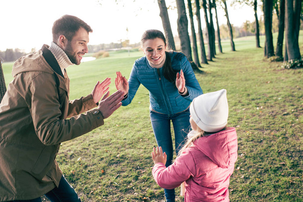 Happy family playing in park - Zdjęcie, obraz