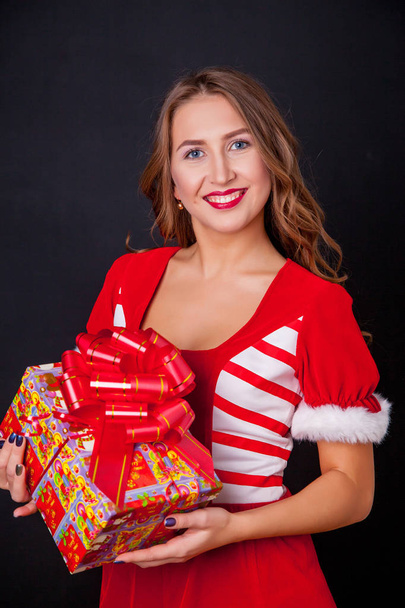 Beautiful happy girl in Santa Claus clothes - Photo, image