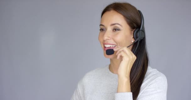 Beautiful and positive female call center agent at work - Felvétel, videó