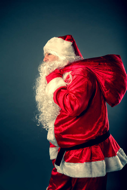 Santa Claus carries a bag with gifts. - Fotoğraf, Görsel