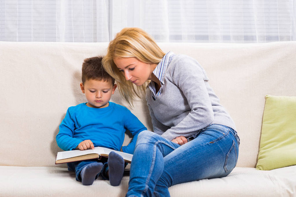 Mother and son  reading book together. - Photo, Image