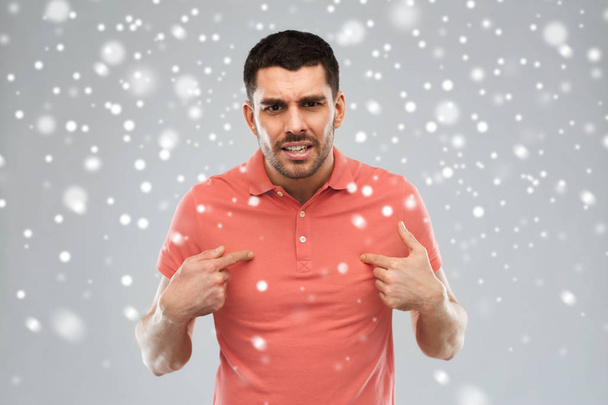 angry man pointing finger to himself over snow - Photo, Image