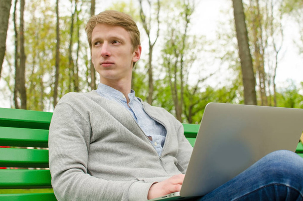 Young man using his laptop - Photo, image