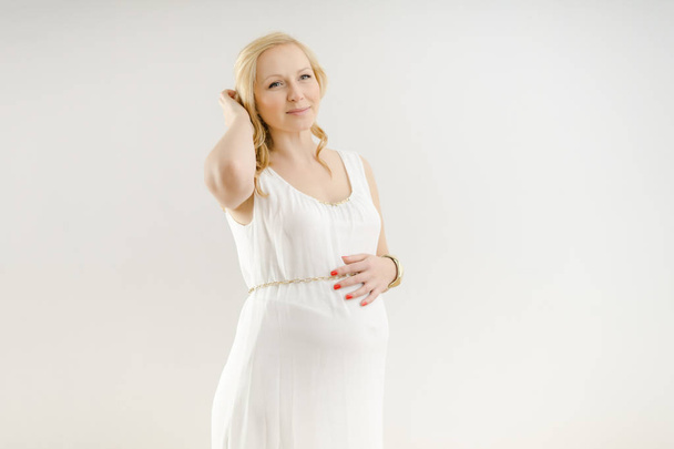 pregnant woman on a white background - Φωτογραφία, εικόνα