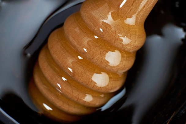 Bowl of honey with a dipper - Zdjęcie, obraz