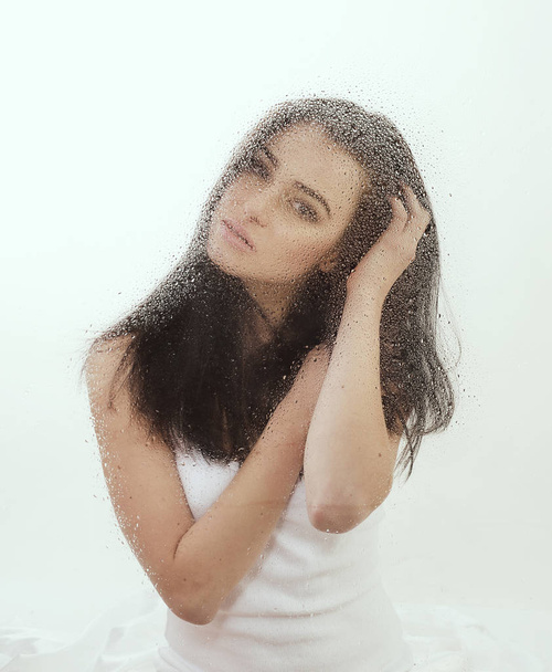 young woman in wet window - Valokuva, kuva