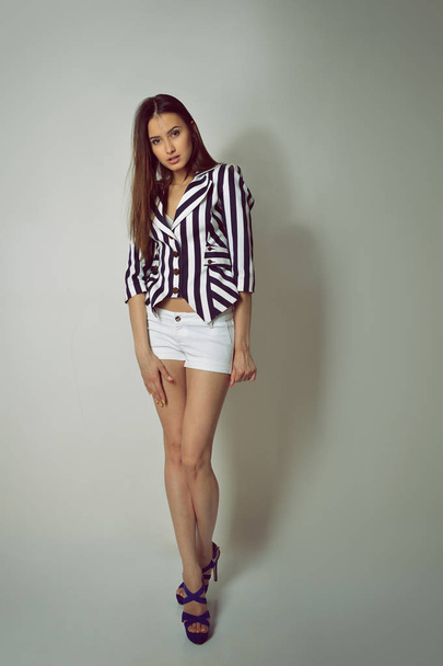 brunette woman in striped jacket - Foto, Imagem
