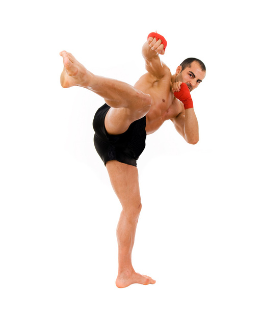 Young Boxer fighter making a kick over white background - Foto, Imagem