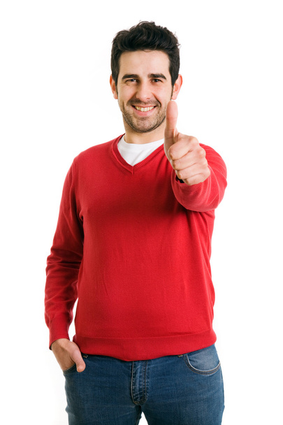Happy casual young man showing thumb up and smiling isolated on - Foto, Bild