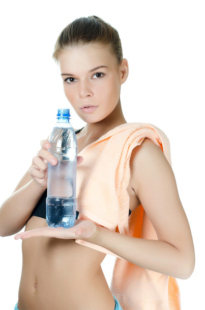 The sports girl with a towel and a water bottle - 写真・画像