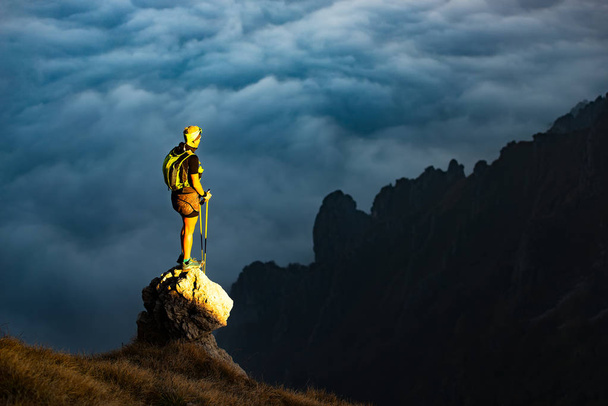 Fantastic sunset in mountains with hiker on a stone where he arr - Photo, Image