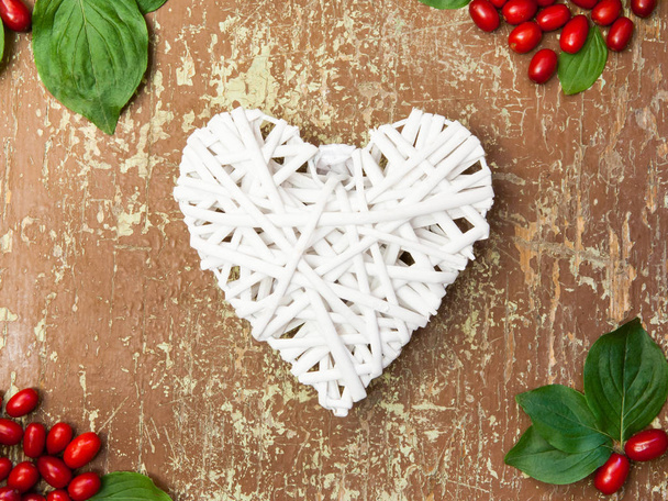 Red berries and white heart shape - Photo, Image