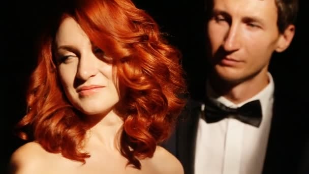 Redhead curly bride looks at groom behind her - Video, Çekim