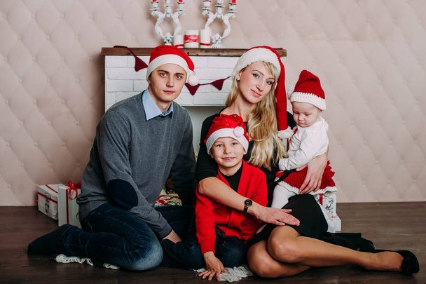 Portrait of friendly family looking at camera on Christmas evening - Фото, зображення