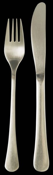 Cuchillo de cena y tenedor de acero inoxidable aislados sobre fondo negro
 - Foto, Imagen