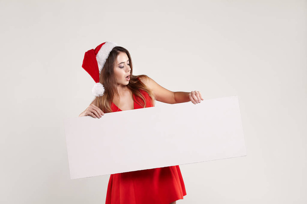 Horizontal portrait of christmas girl with plate on white background - Φωτογραφία, εικόνα