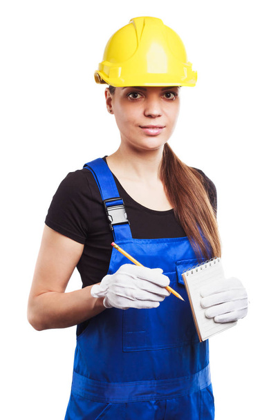 Woman builder in the uniform with a notebook - Foto, Imagen