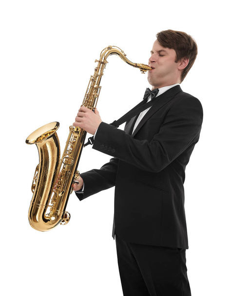Saxophonist in a tuxedo plays music on sax. - Fotó, kép