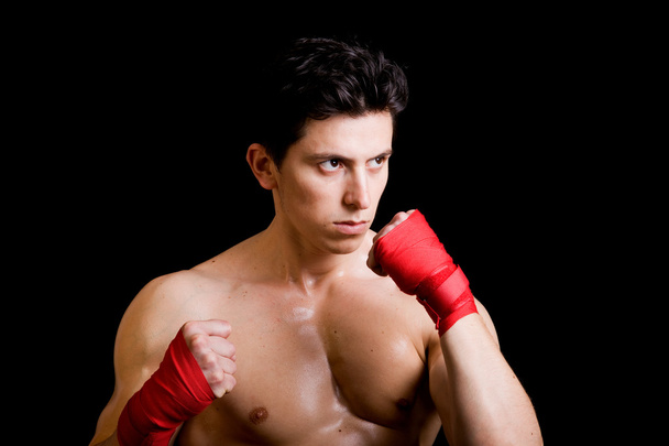 Young Boxer fighter over black background - Photo, Image