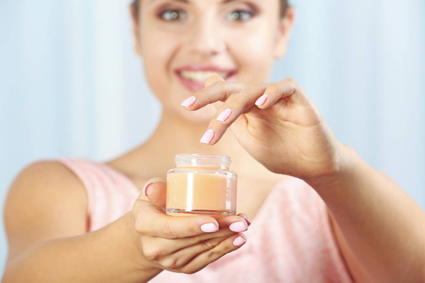 Jar of cream in female hands, close up - Фото, зображення