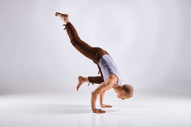 man doen yoga geïsoleerd op witte achtergrond - Foto, afbeelding