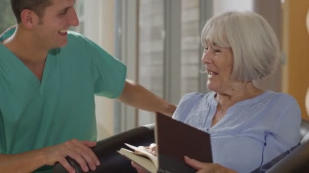 nurse giving support to elderly patient - Video, Çekim