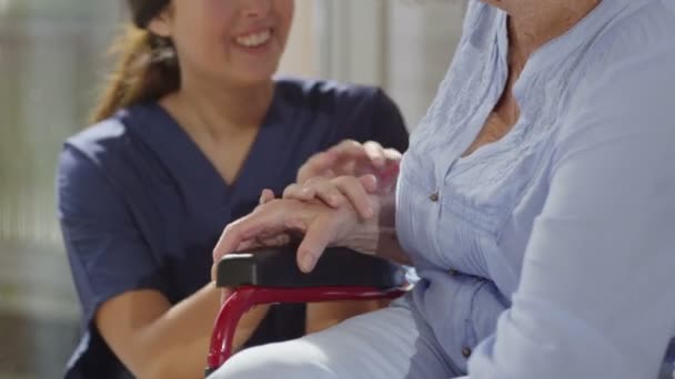 nurse giving support to elderly patient - Felvétel, videó