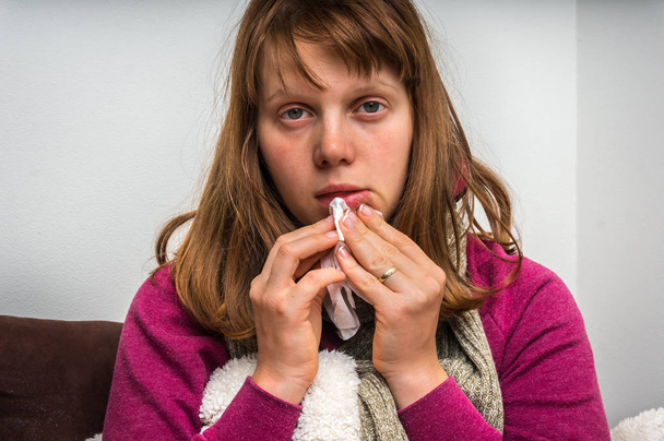 Sick woman having flu and sneezing into handkerchief - Photo, Image