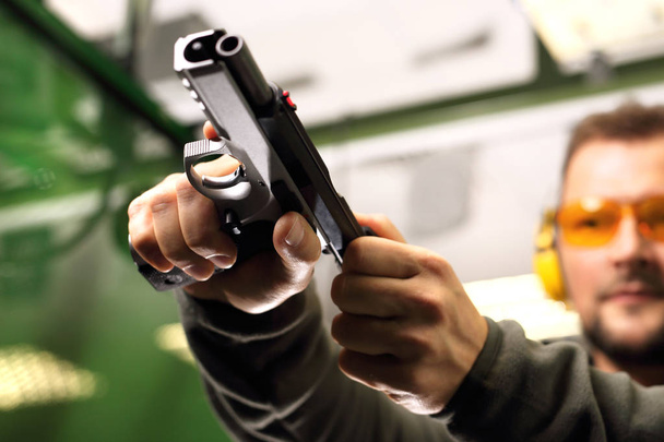 Shooting a gun at a shooting range. - Photo, image