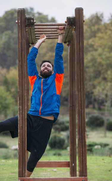 bearded man takes exercise in the park - Photo, Image