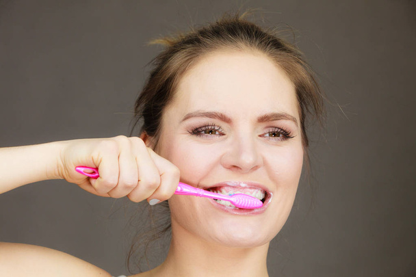 Woman brushing cleaning teeth - 写真・画像