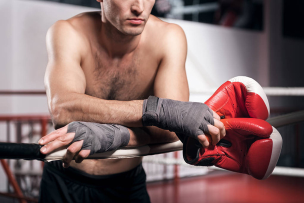 Close up of boxer leaning on ring rope - 写真・画像