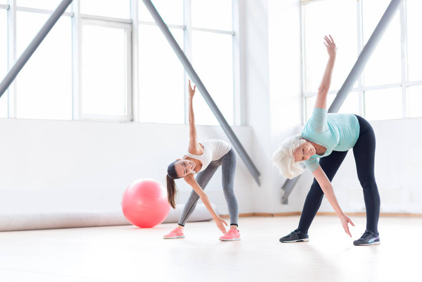 Active cheerful women exercising in a fitness club - Zdjęcie, obraz