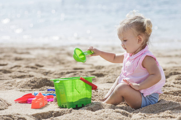 girl playing sand toys at beach - 写真・画像