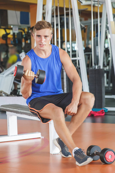 man exercising with dumbbell at gym - Foto, immagini
