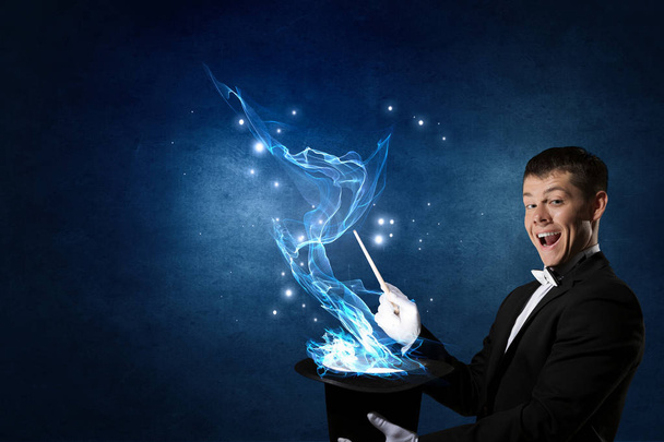 Businessman demonstrating magic . Mixed media - Foto, imagen