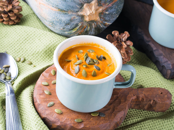Pumpkin cream soup in green pastel mug - Photo, Image