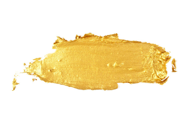 Beroertes van gouden verf geïsoleerd op witte achtergrond - Foto, afbeelding