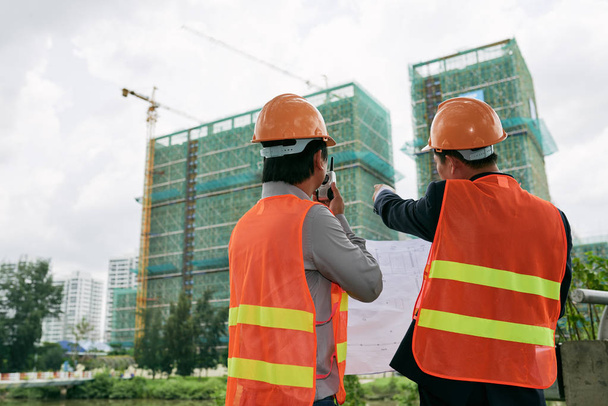 Contractor and engineer examining construction site - Photo, Image