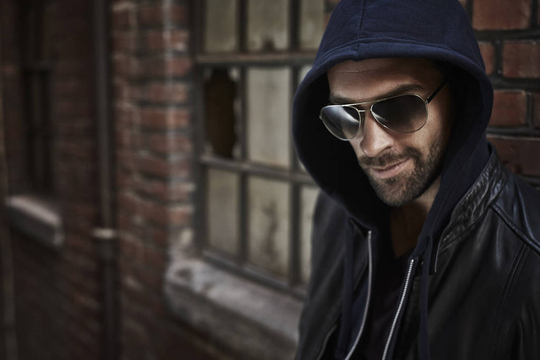 Handsome man in sunglasses and hood - Photo, Image