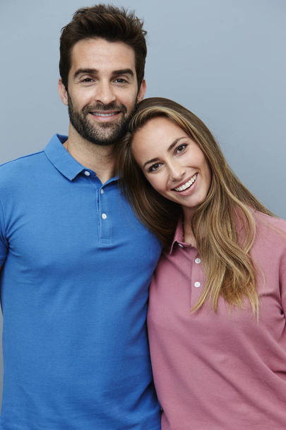 Smiling couple in polo shirts - 写真・画像