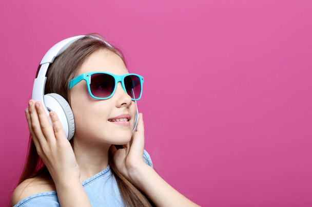Portrait of young girl with headphones  - Фото, изображение