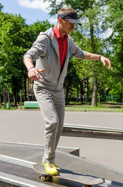 Young man with skateboard - Fotó, kép