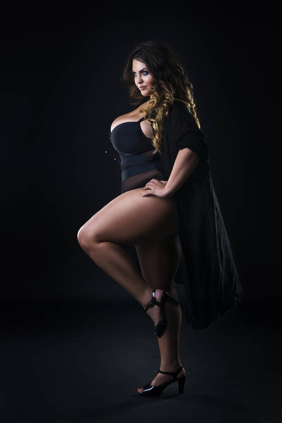Young beautiful plus size model in underwear, xxl woman on black background - Foto, Bild