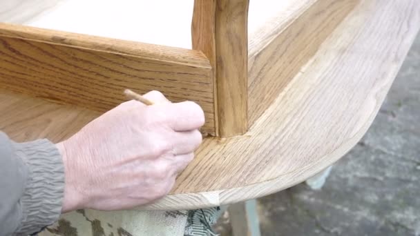 Carpenter is covering table by lacquer - Footage, Video