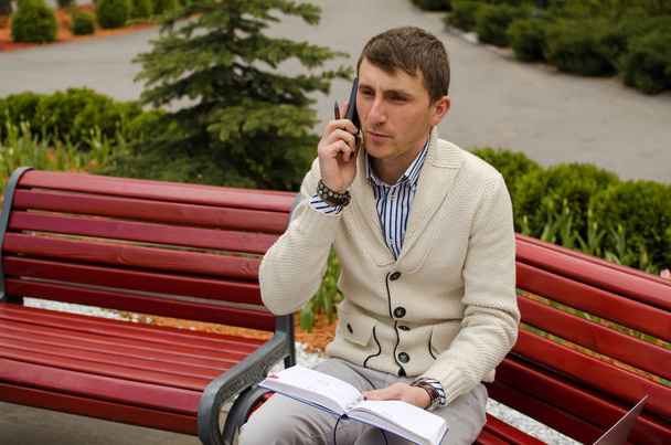 Young man is talking on the phone - Fotó, kép